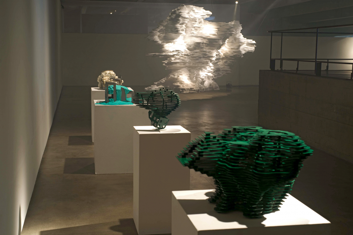 In Void — a visitor moving through the suspended paper landscape in low light